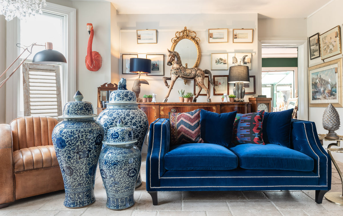 Vintage Frog, Surrey UK antique and vintage furniture shop and showroom Hero Image. Two seater blue velvet sofa