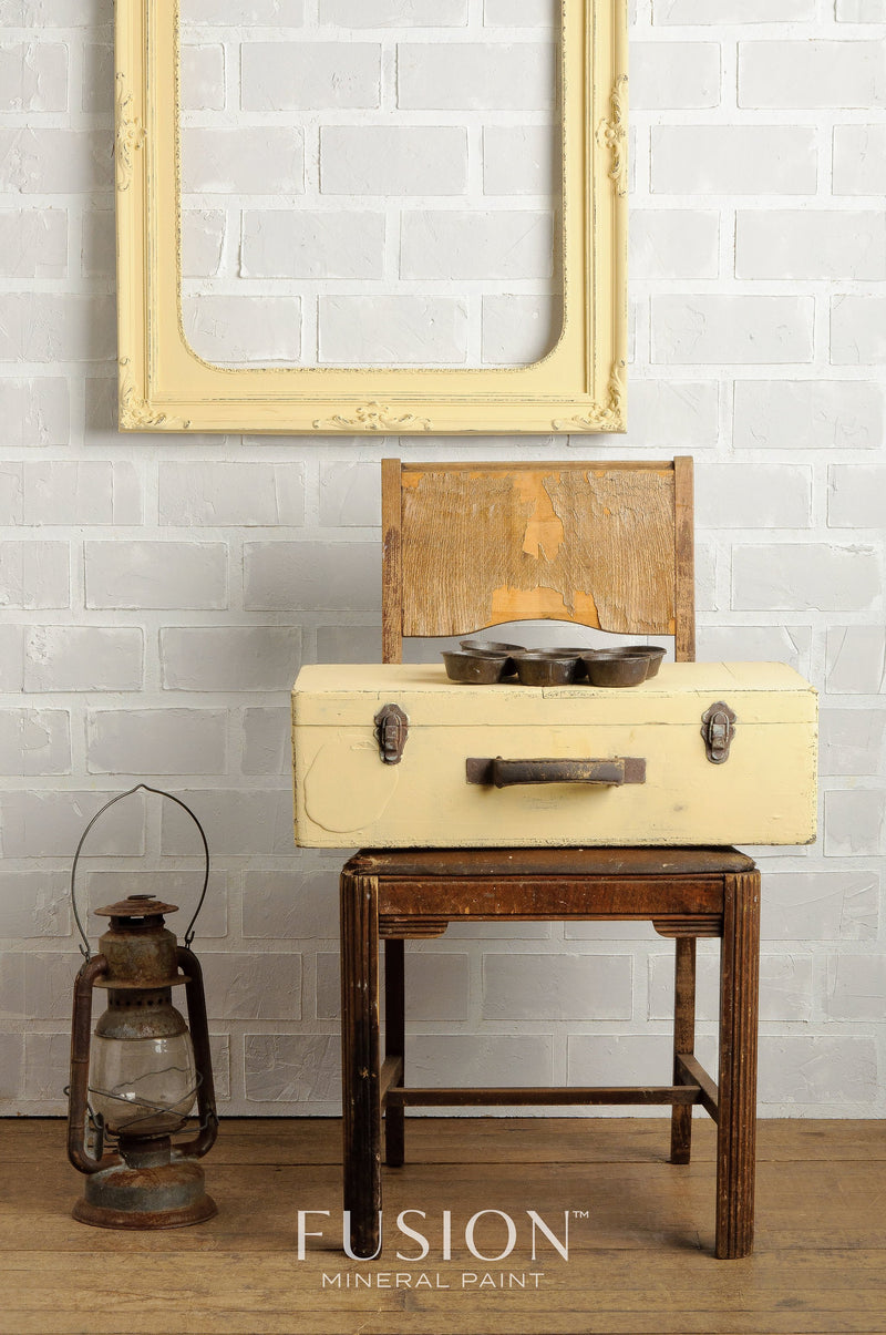 buttermilk cream lifestyle shot of a suitcase on a chair by fusion mineral paint